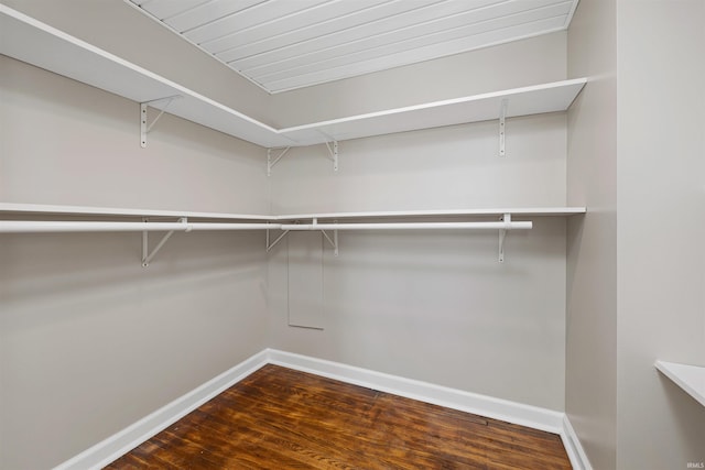 spacious closet with dark wood finished floors