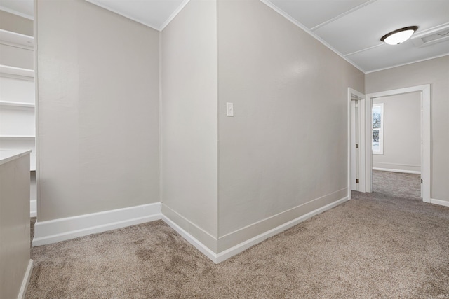 hallway featuring light carpet, ornamental molding, visible vents, and baseboards