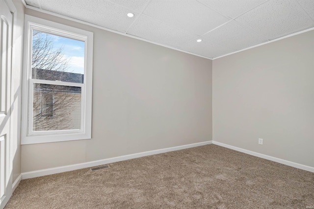 carpeted spare room with a drop ceiling, recessed lighting, visible vents, and baseboards