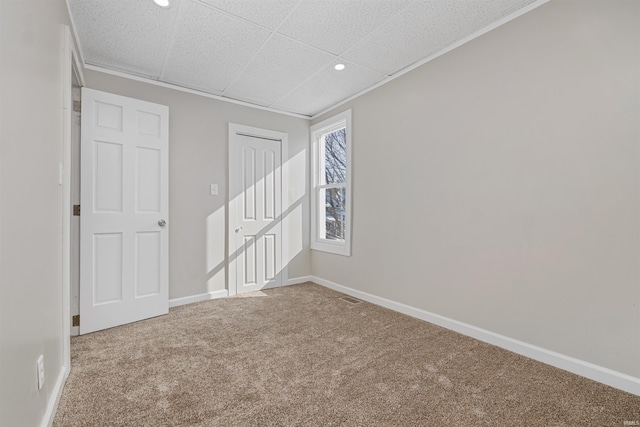 carpeted empty room with a paneled ceiling, recessed lighting, visible vents, and baseboards