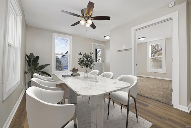 dining room with dark wood finished floors, baseboards, and ceiling fan