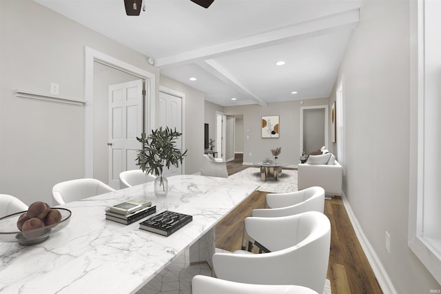 interior space with dark wood-style floors, light stone counters, a breakfast bar area, recessed lighting, and baseboards