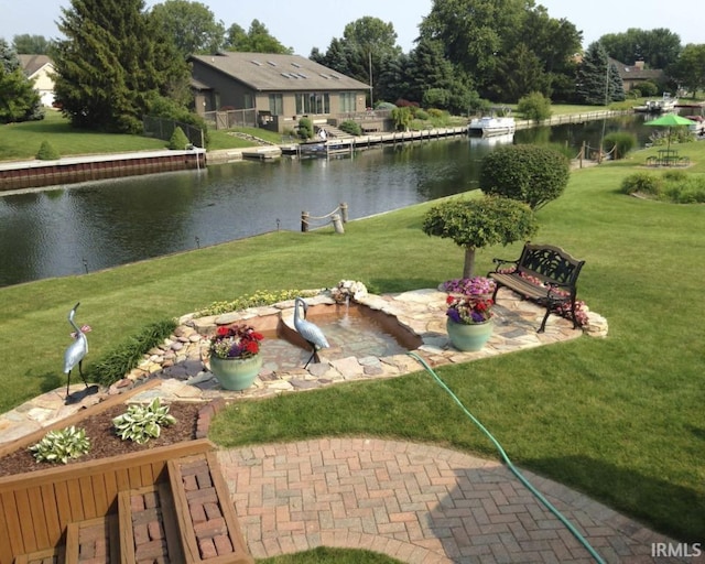 view of home's community featuring a water view and a lawn