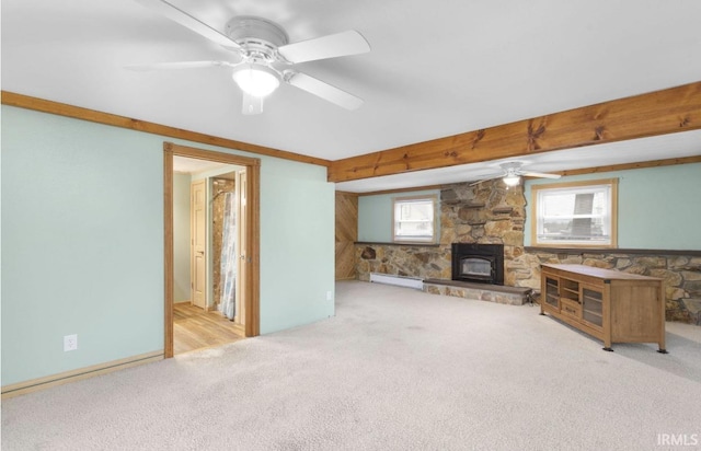 unfurnished living room with a ceiling fan, light carpet, a stone fireplace, and baseboard heating