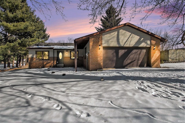 view of front of house featuring brick siding and an attached garage