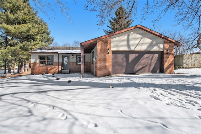 view of front of home featuring a garage and brick siding