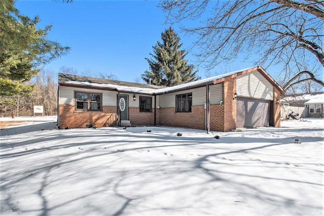 single story home with a garage and brick siding