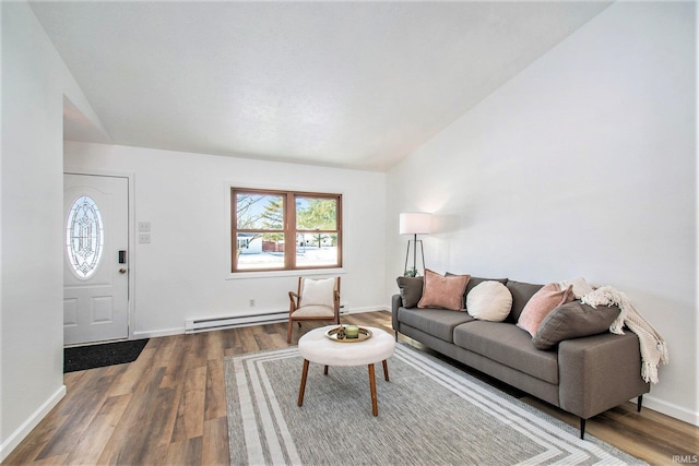 living room with a baseboard heating unit, lofted ceiling, baseboards, and wood finished floors