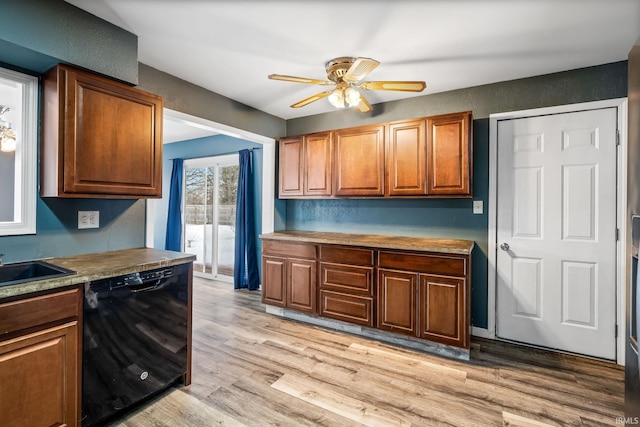 kitchen with brown cabinetry, light wood-type flooring, light countertops, and dishwasher