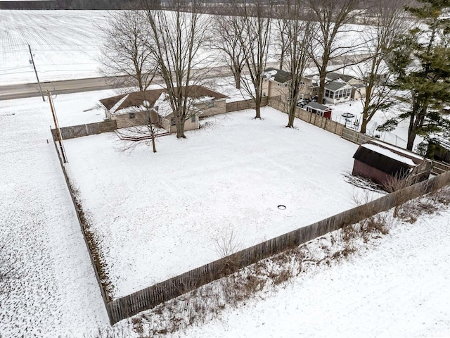 yard covered in snow with fence