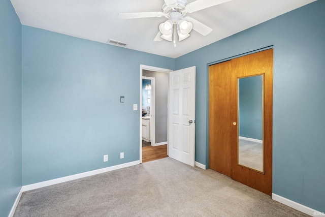 unfurnished bedroom featuring light carpet, baseboards, and visible vents