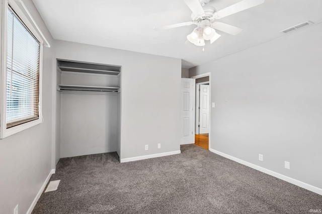 unfurnished bedroom featuring baseboards, carpet, visible vents, and a closet