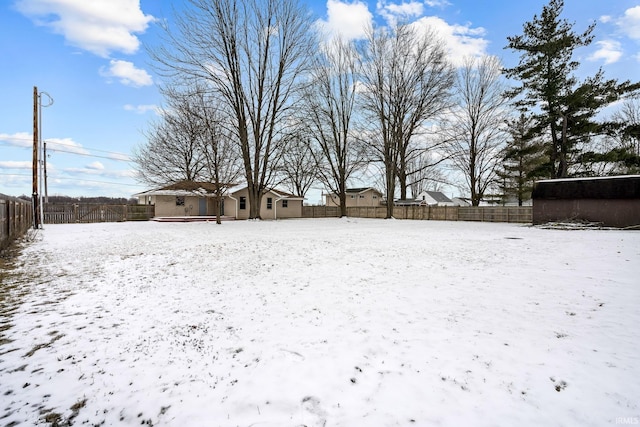 yard layered in snow with fence