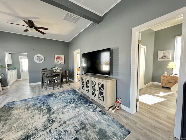 living area with visible vents, vaulted ceiling with beams, baseboards, and wood finished floors