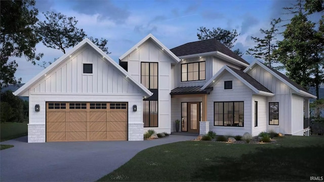 modern farmhouse style home featuring board and batten siding, a front yard, a standing seam roof, a garage, and driveway