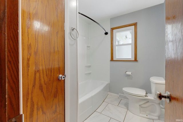 bathroom featuring toilet, marble finish floor, baseboards, and shower / bathing tub combination