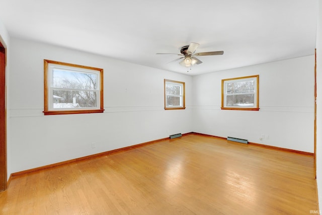 empty room with light wood-style floors, ceiling fan, and baseboards