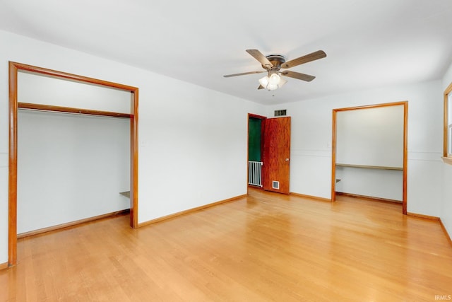 unfurnished bedroom with light wood finished floors, a ceiling fan, visible vents, and baseboards