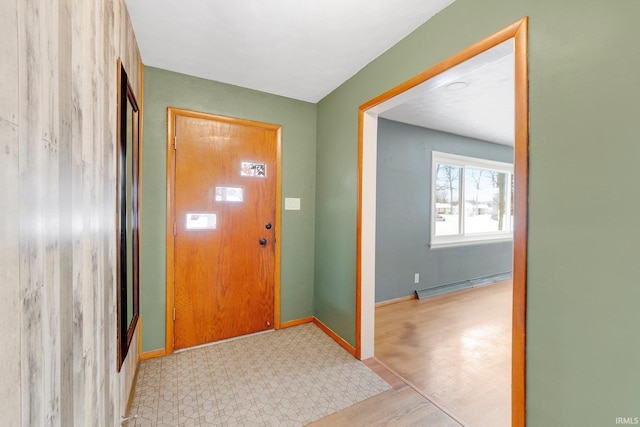 entrance foyer with light floors, a baseboard radiator, and baseboards