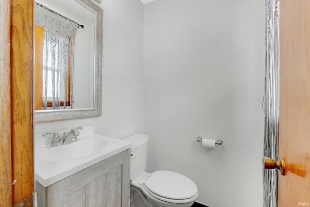 bathroom with toilet and vanity