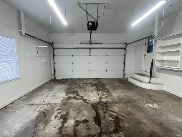 garage featuring baseboards and a garage door opener