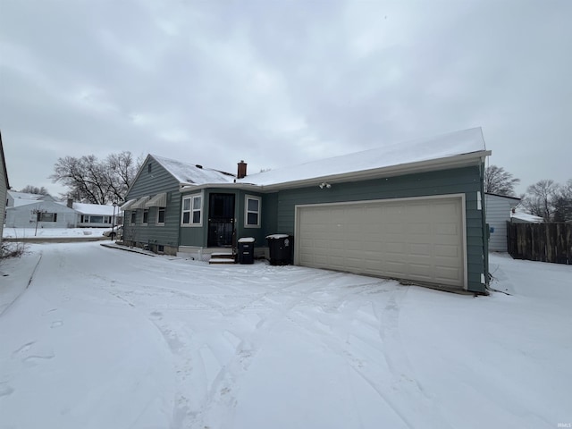 view of front of home with a chimney and an attached garage