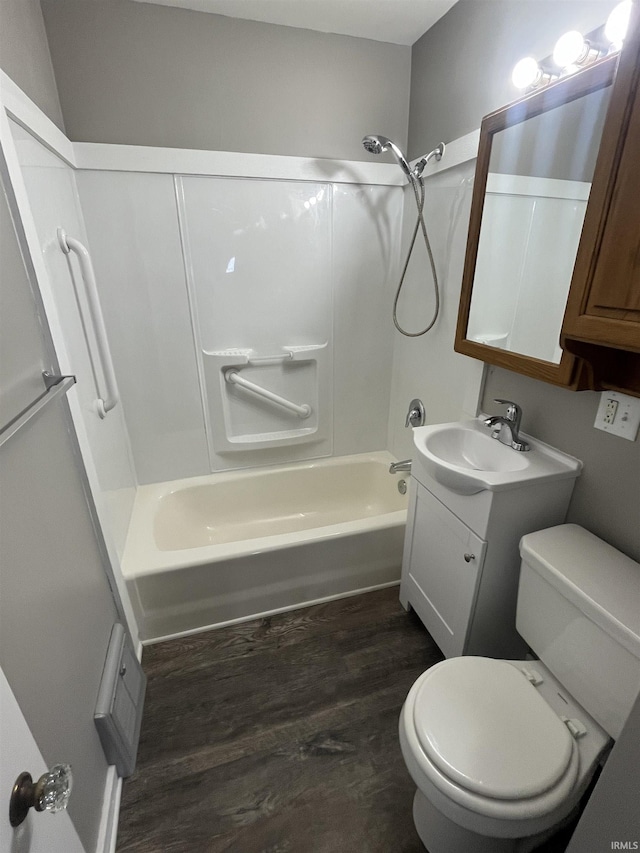 full bath featuring toilet, bathtub / shower combination, wood finished floors, and vanity