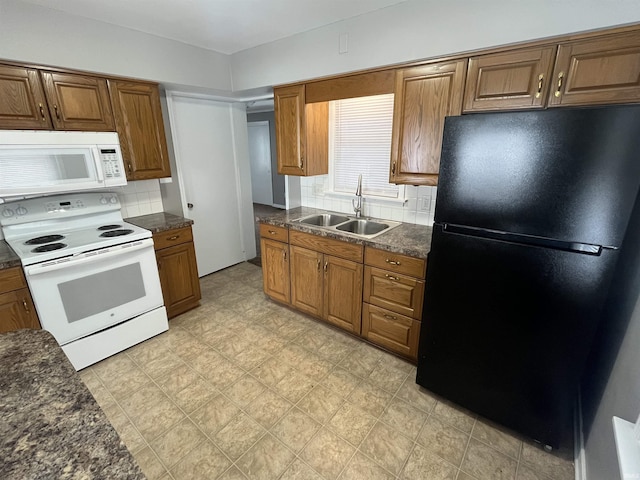 kitchen with white appliances, backsplash, a sink, and brown cabinetry