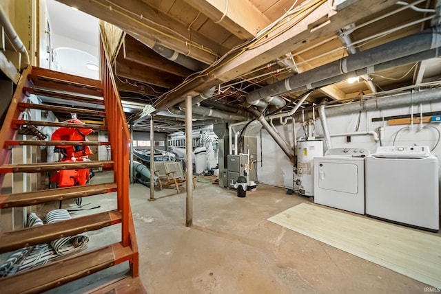 unfinished below grade area featuring water heater, washing machine and clothes dryer, and heating unit