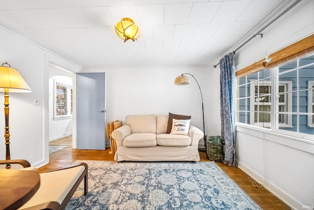 living area with wood finished floors and baseboards