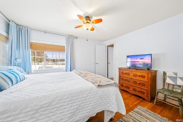 bedroom with light wood-style flooring and a ceiling fan