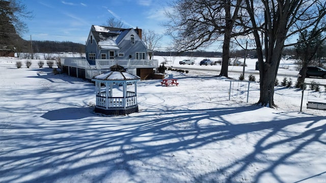 view of snow covered exterior with a deck