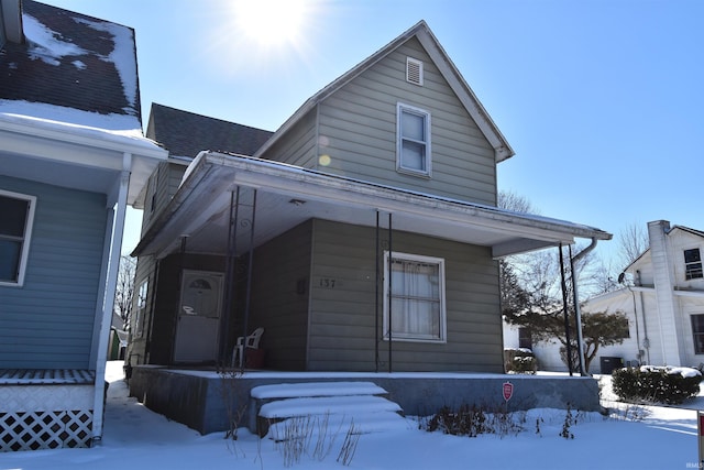 view of front of property featuring a porch and roof with shingles