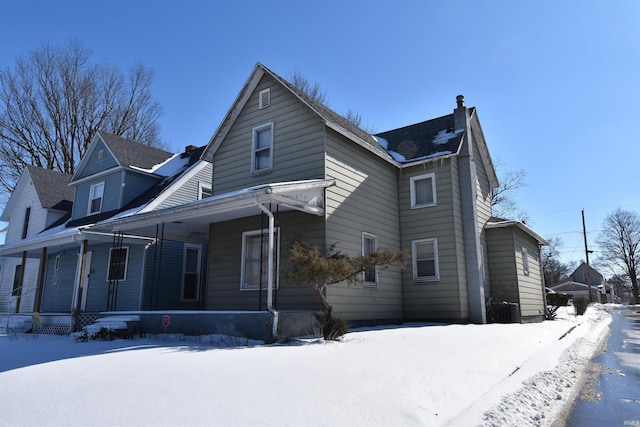 view of front of property featuring covered porch and a chimney