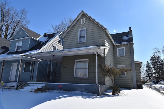 view of front facade with covered porch and roof with shingles