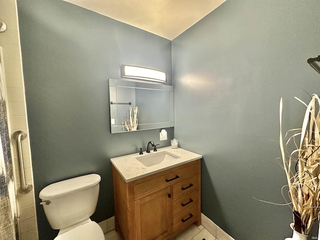 bathroom with baseboards, vanity, toilet, and tile patterned floors