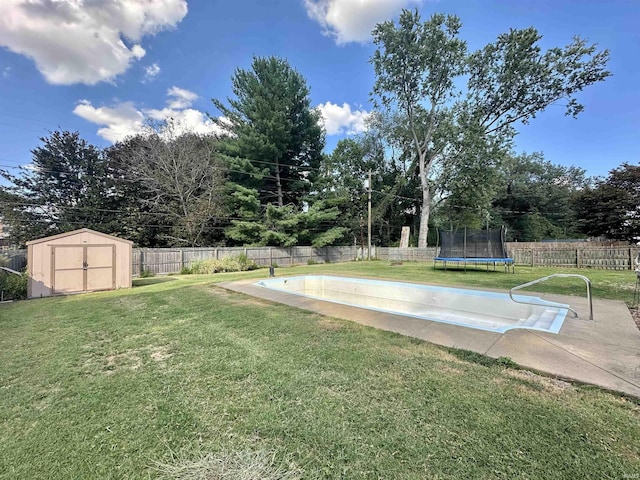 view of yard with a fenced backyard, a trampoline, a storage unit, and an outdoor structure