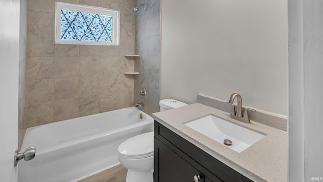 bathroom featuring shower / bathtub combination, toilet, and vanity