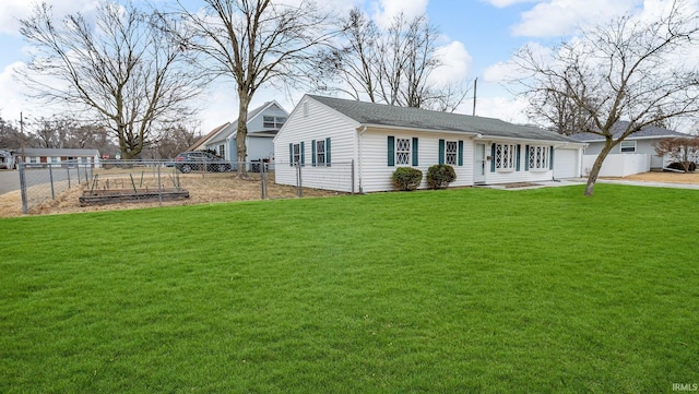 view of front of house featuring a garage, a garden, fence, and a front yard