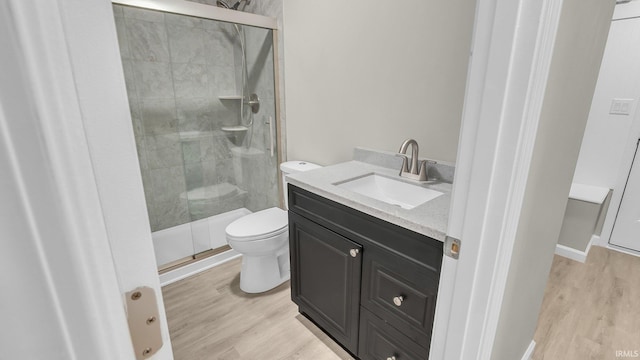 full bath with vanity, wood finished floors, toilet, and a shower stall