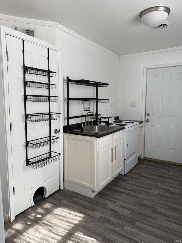 kitchen with dark wood-type flooring, white cabinetry, ornamental molding, dark countertops, and white electric range oven