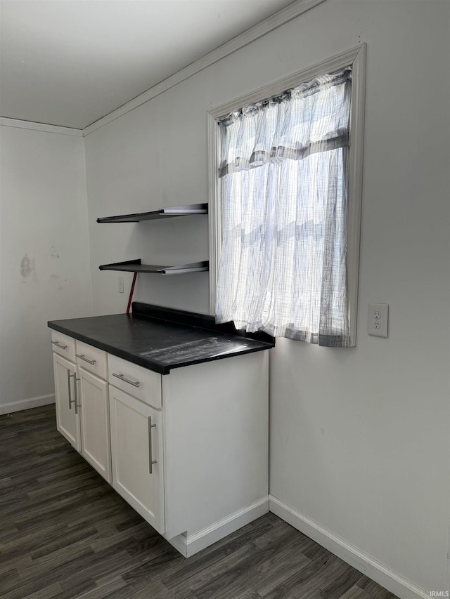 kitchen featuring dark countertops, a healthy amount of sunlight, white cabinets, and open shelves