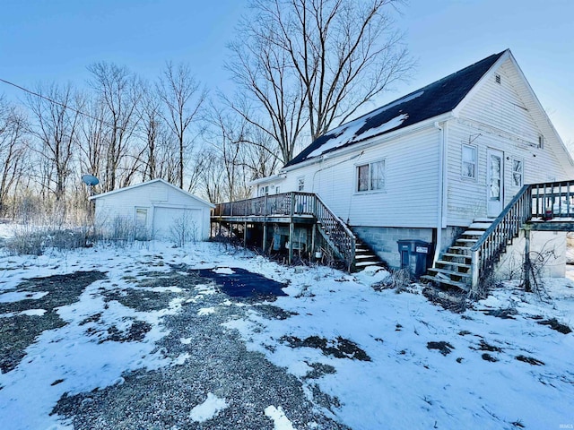 exterior space with stairway, a deck, and an outdoor structure