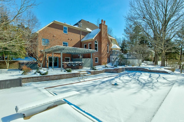 snow covered pool featuring stairway, a jacuzzi, and a pergola