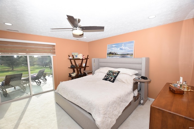 bedroom with visible vents, light colored carpet, ceiling fan, access to outside, and a textured ceiling