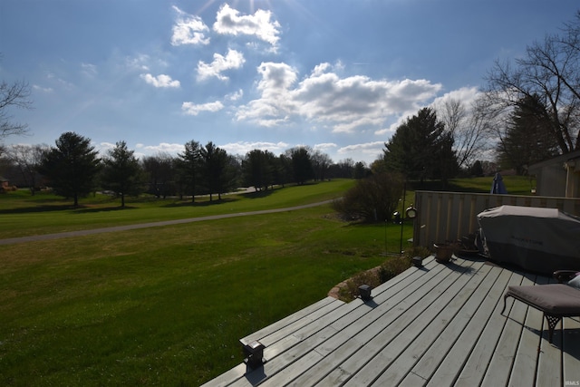 wooden deck with a grill and a yard