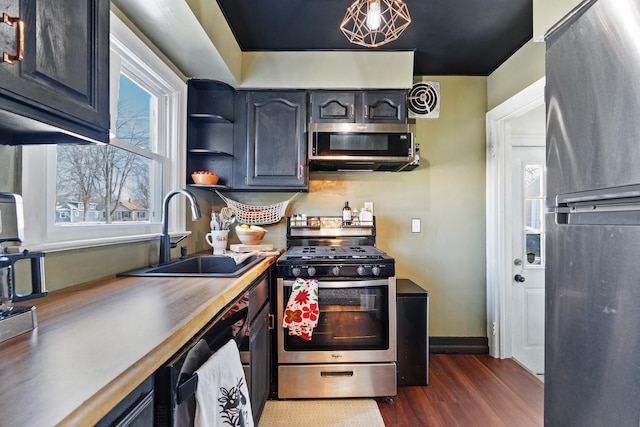 kitchen with a sink, visible vents, appliances with stainless steel finishes, dark wood-style floors, and open shelves