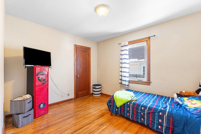 bedroom featuring wood finished floors and baseboards