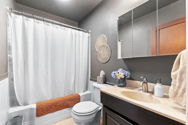 bathroom featuring vanity, toilet, and shower / bath combo with shower curtain