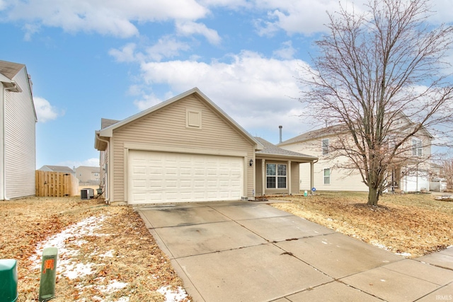 single story home featuring driveway, an attached garage, and central air condition unit